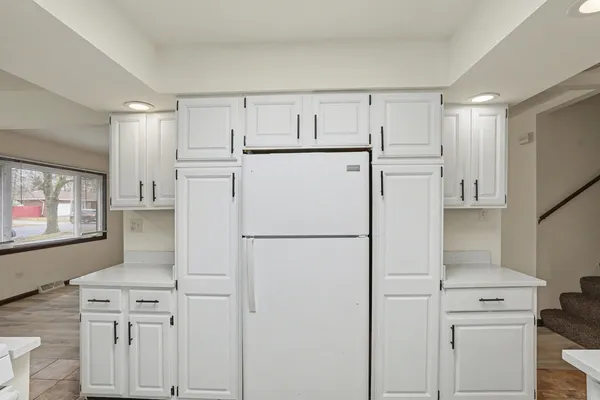 a white refrigerator freezer sitting inside of a kitchen