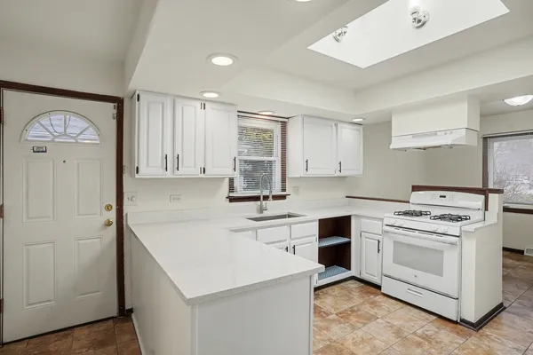 a kitchen that has a sink and a stove in it