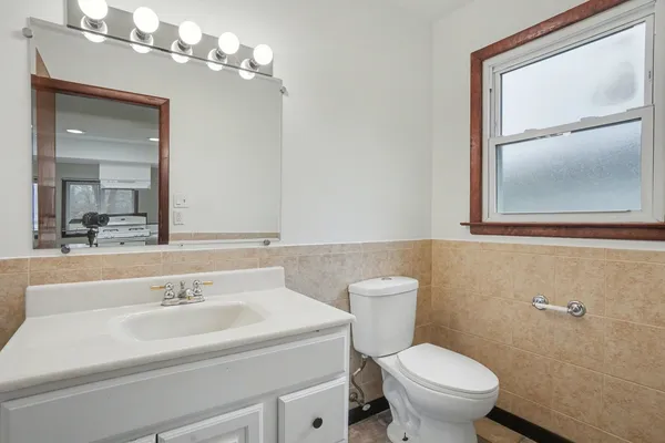 a bathroom with a sink a mirror and a toilet