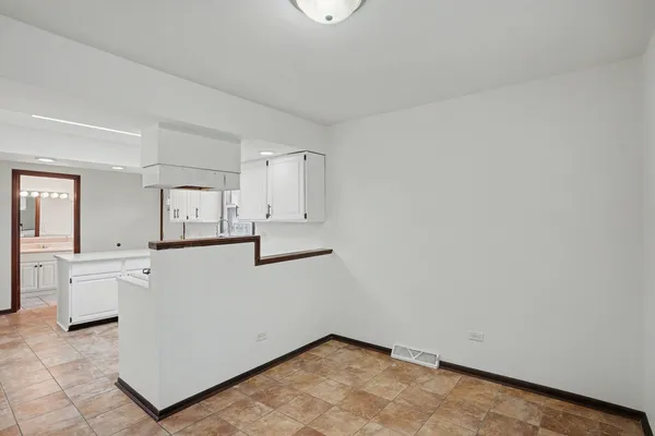 a view of kitchen with white cabinets