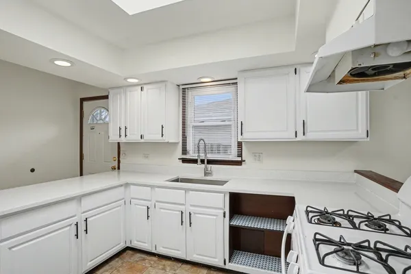 a kitchen with a sink cabinets and appliances