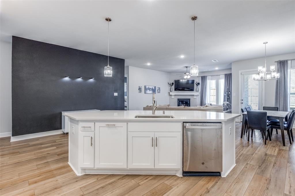 356 Greenbriar Road Little Elm, TX 75068 - Photo 25 of 25 Kitchen featuring open floor plan, dishwasher, white cabinets, a kitchen island with sink, and light wood-style flooring