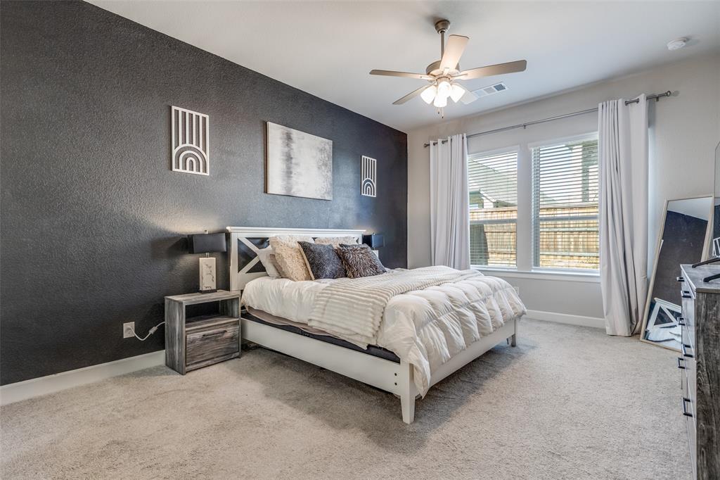 356 Greenbriar Road Little Elm, TX 75068 - Photo 16 of 25 Bedroom featuring light carpet, ceiling fan, and an accent wall