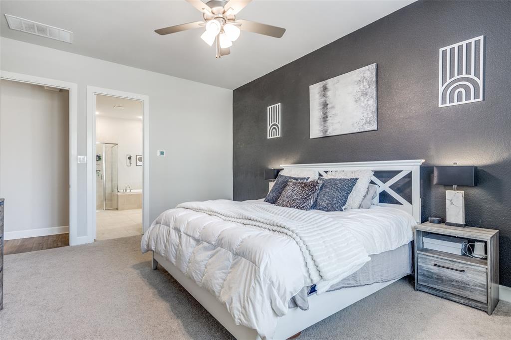 356 Greenbriar Road Little Elm, TX 75068 - Photo 17 of 25 Bedroom featuring light colored carpet, an accent wall, a ceiling fan, and ensuite bathroom
