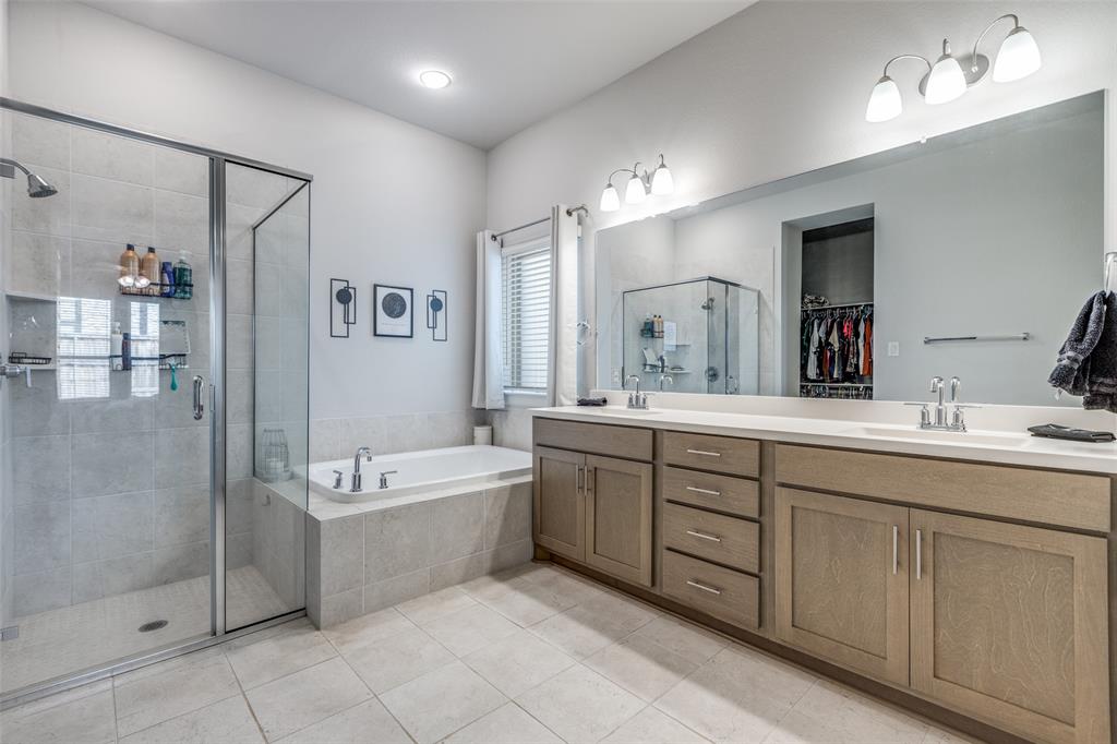 356 Greenbriar Road Little Elm, TX 75068 - Photo 18 of 25 Bathroom featuring a stall shower, a bath, double vanity, a walk in closet, and light tile patterned floors