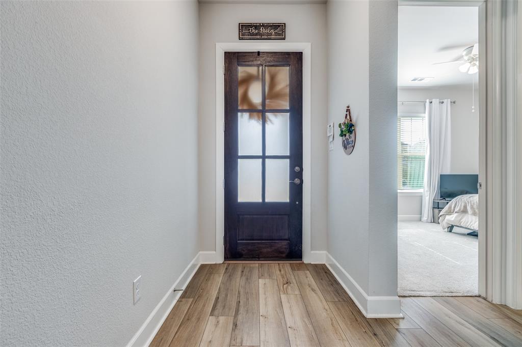 356 Greenbriar Road Little Elm, TX 75068 - Photo 3 of 25 Entrance foyer with light wood-type flooring, a ceiling fan, and a textured wall