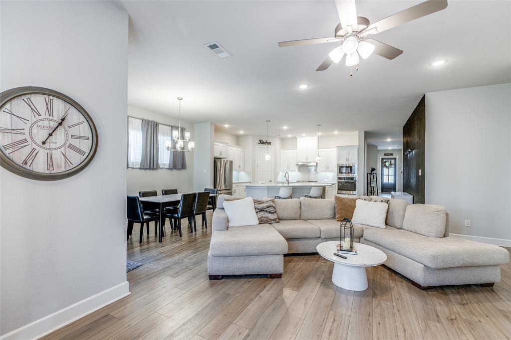 356 Greenbriar Road Little Elm, TX 75068 - Photo 9 of 25 Living area featuring ceiling fan, light wood-style floors, and a chandelier