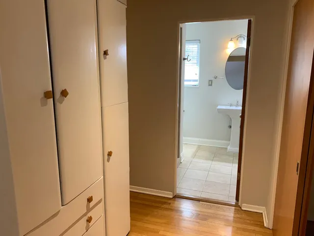 a view of a bathroom from a corridor