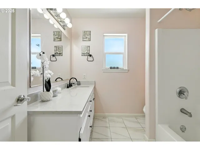 a bathroom with a sink a mirror and shower
