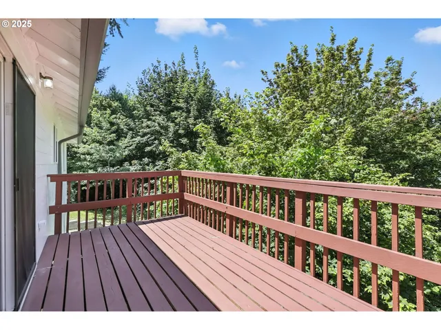 a view of a wooden deck with a yard
