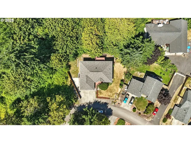 an aerial view of a house with a yard