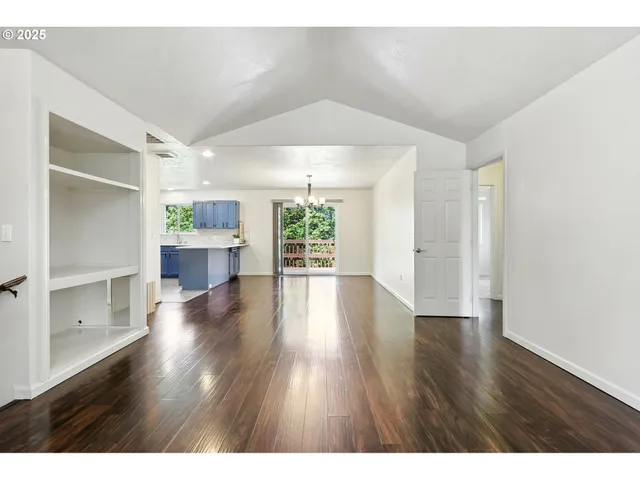 a view interior of a house wooden floor an entryway and a room
