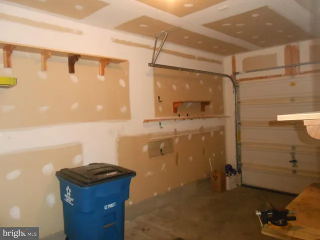 a bathroom with a granite countertop sink a mirror and shower