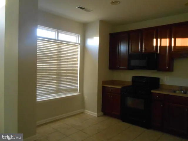 a kitchen with a window and cabinets