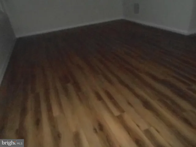 a view of a closet with wooden floor