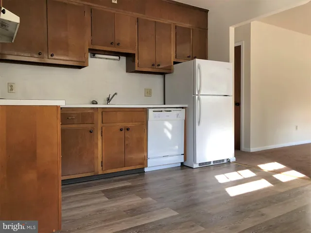 a kitchen with a refrigerator and cabinets