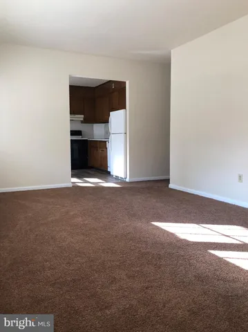a view of empty room with a fireplace