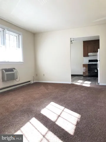 a view of a livingroom with furniture and an empty room