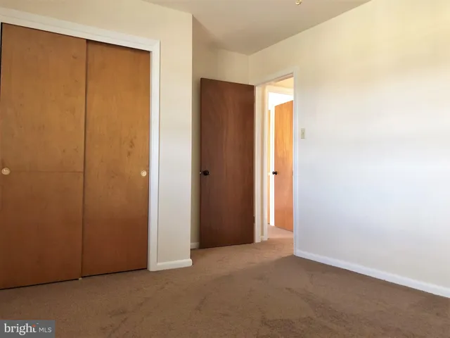 an empty room with closet area