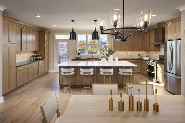 a large kitchen with a table and chairs