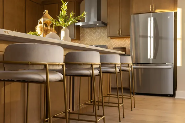 a kitchen with stainless steel appliances granite countertop a refrigerator and cabinets