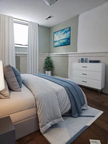 a bedroom with a bed and a window