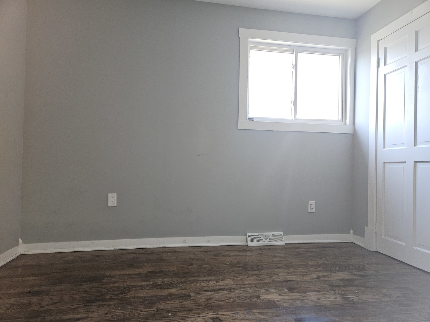 6732 South Peoria Street Chicago, IL 60621 - Photo 18 of 22 an empty room with wooden floor and windows