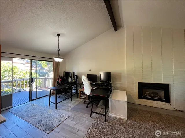 a living room with furniture a fireplace and a flat screen tv
