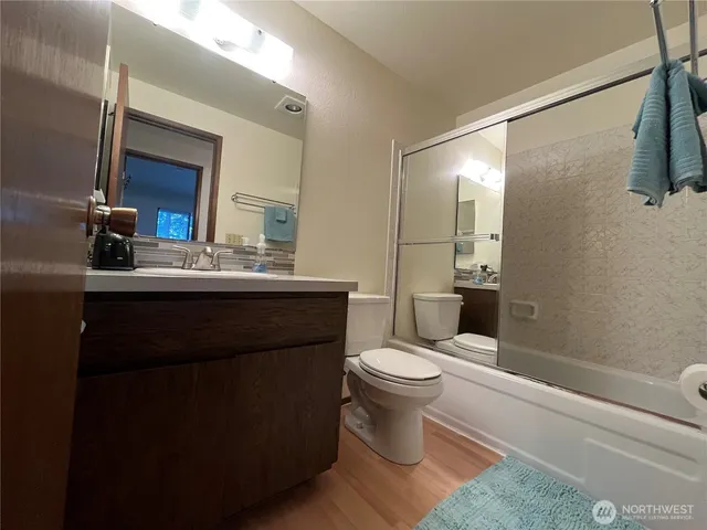 a bathroom with a sink toilet a mirror and shower