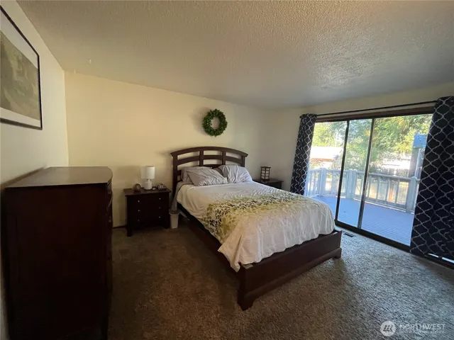 a spacious bedroom with a bed and a large window