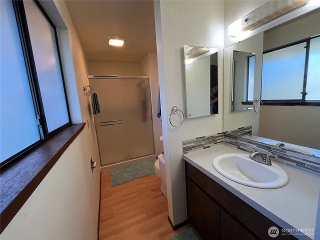 a bathroom with a sink a mirror and a shower