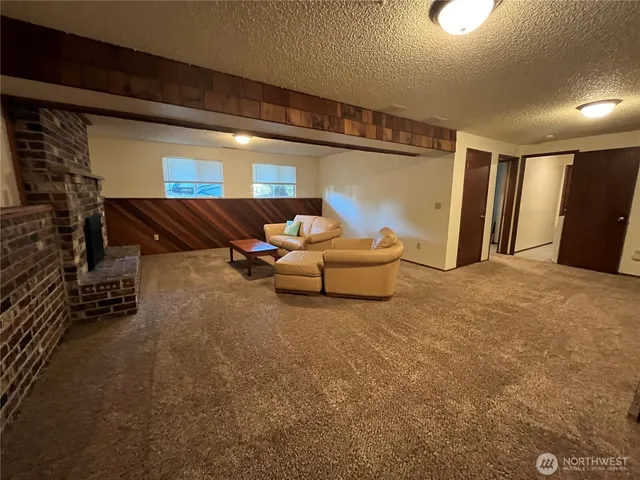 a living room with furniture and a ceiling fan