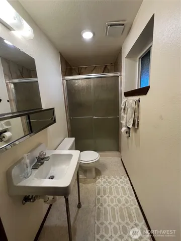 a bathroom with a sink toilet and shower