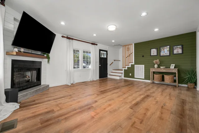 a view of an empty room with a fireplace and a window