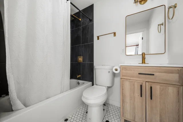 a bathroom with a toilet a sink and a shower