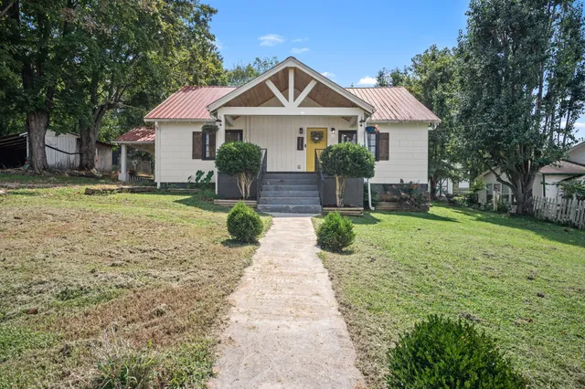 a front view of a house with a yard and porch
