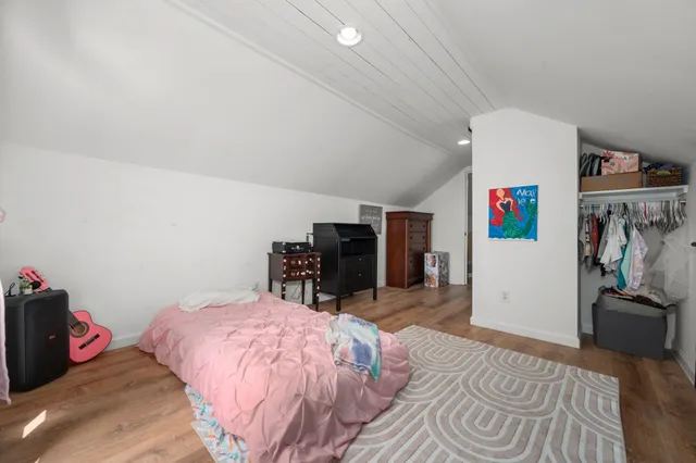 a bedroom with a bed and a couch