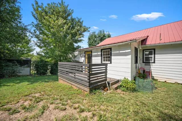 a view of a house with backyard and sitting area