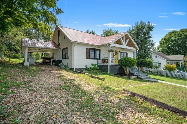 a view of a house with a yard patio and fire pit