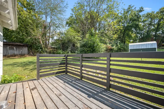 a view of a wooden deck with a yard