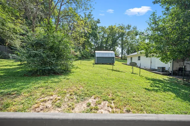 a backyard of a house with chairs and a yard