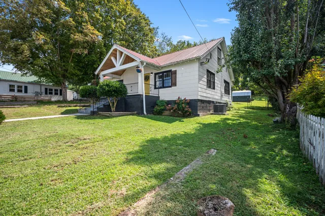 a view of a house with a yard and sitting area