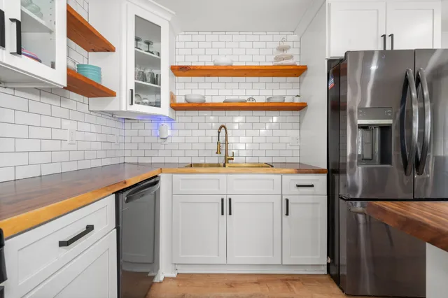 a kitchen with stainless steel appliances a refrigerator and a sink