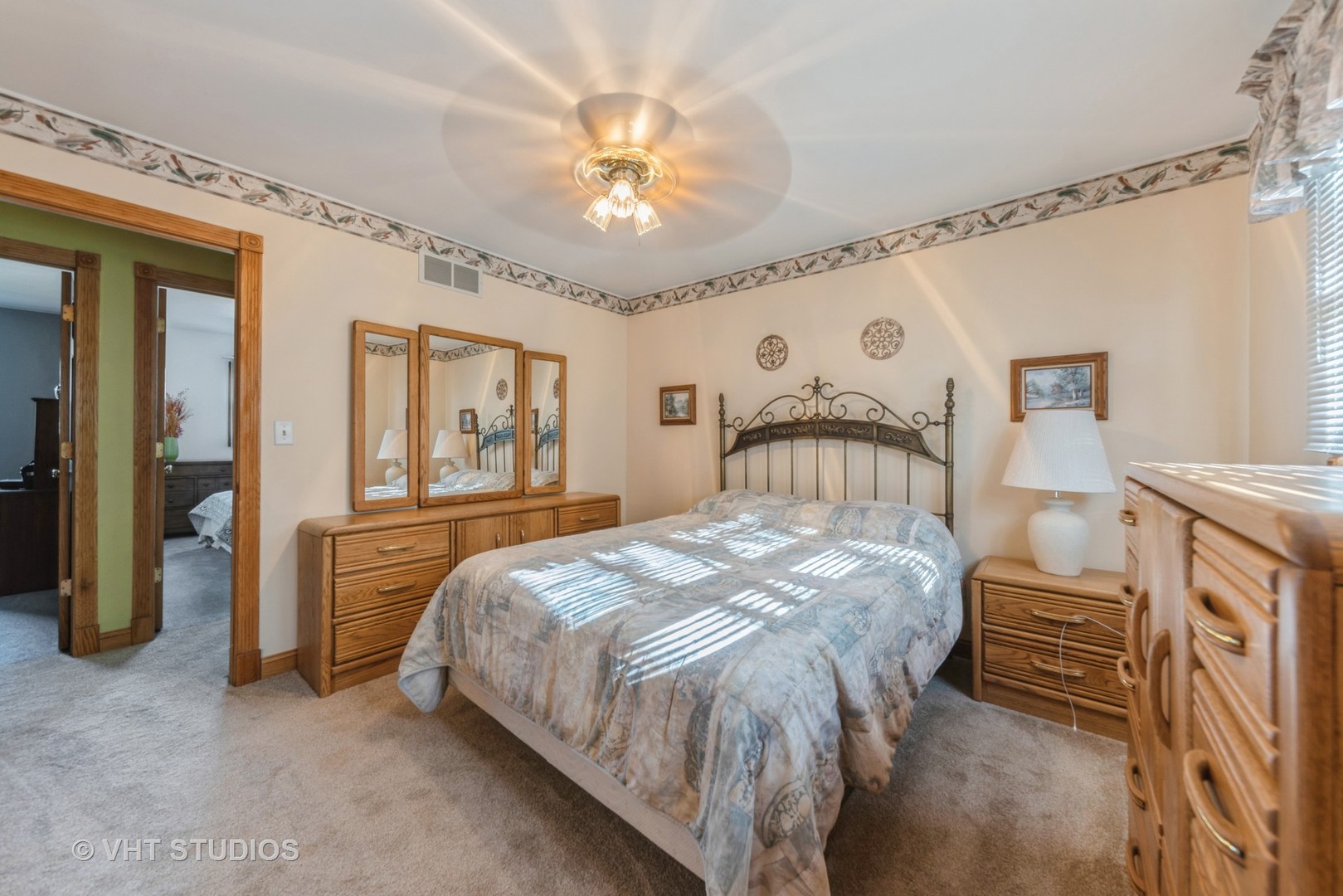 798 Amanda Road New Lenox, IL 60451 - Photo 9 of 20 a bedroom with a bed and a chandelier