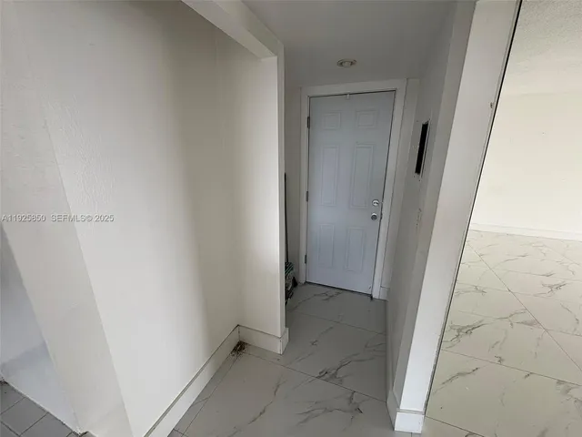 a kitchen with stainless steel appliances a refrigerator a sink a stove a microwave a refrigerator and a dining table