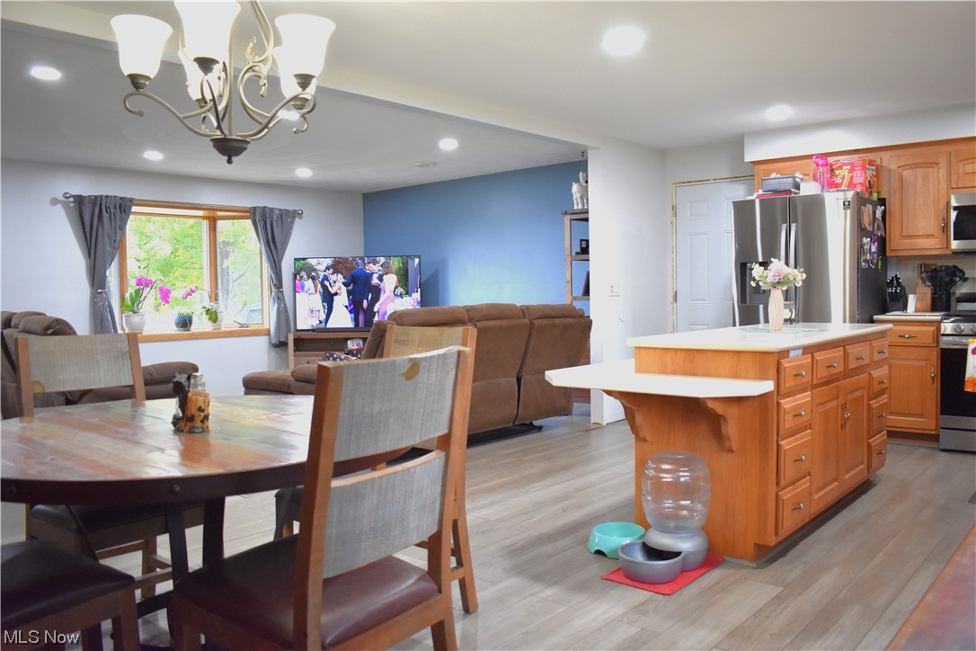 1597 South Funk Road Wooster, OH 44691 - Photo 6 of 35 Dining space with a chandelier and light hardwood flooring