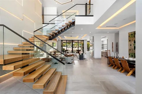a large kitchen with kitchen island a large window in it