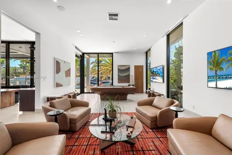 a patio with a table and chairs and potted plants