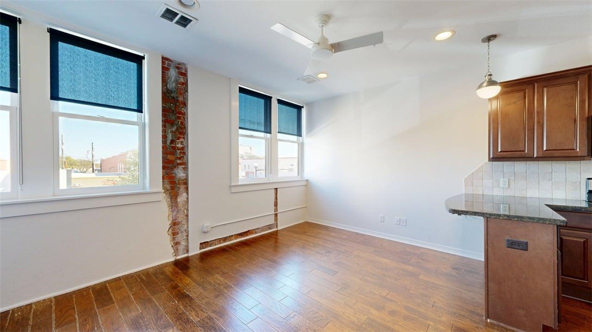206 North Main Street, Unit 124 Bryan, TX 77803 - Photo 4 of 17 a view of an empty room with window and wooden floor