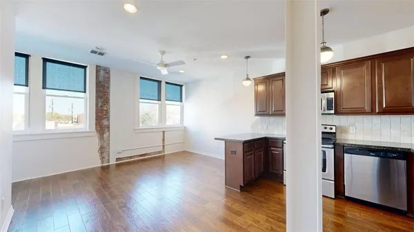 a view of kitchen with wooden floor and electronic appliances